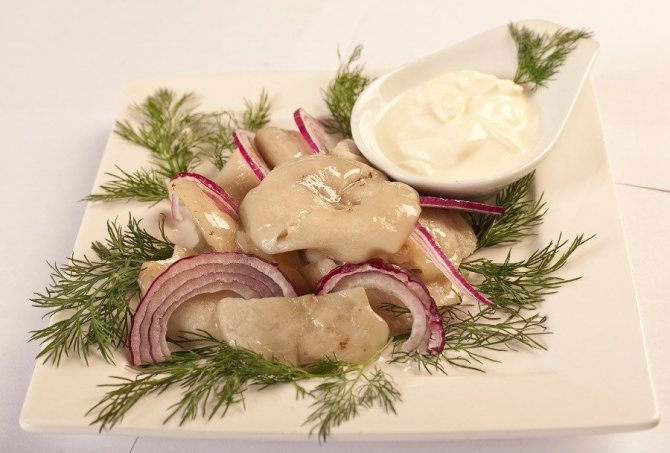 Salted milk mushrooms with sour cream and onions.