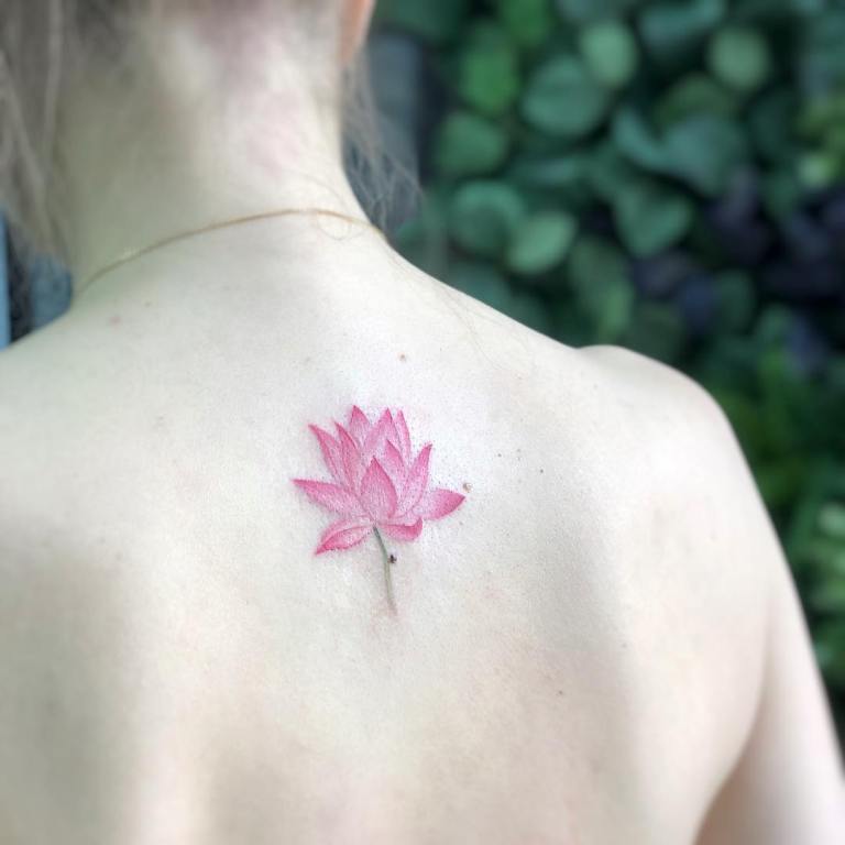 Small lotus on the back tattoo