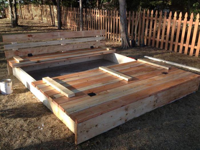 do-it-yourself sandbox made of wood with a lid