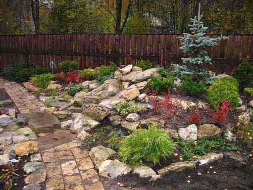 Raised flower beds, rockeries and slides will help to visually expand the space
