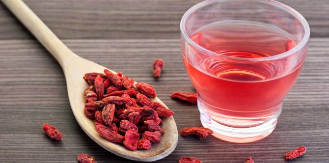 boiled barberry in a glass, dry fruits lie side by side on the table